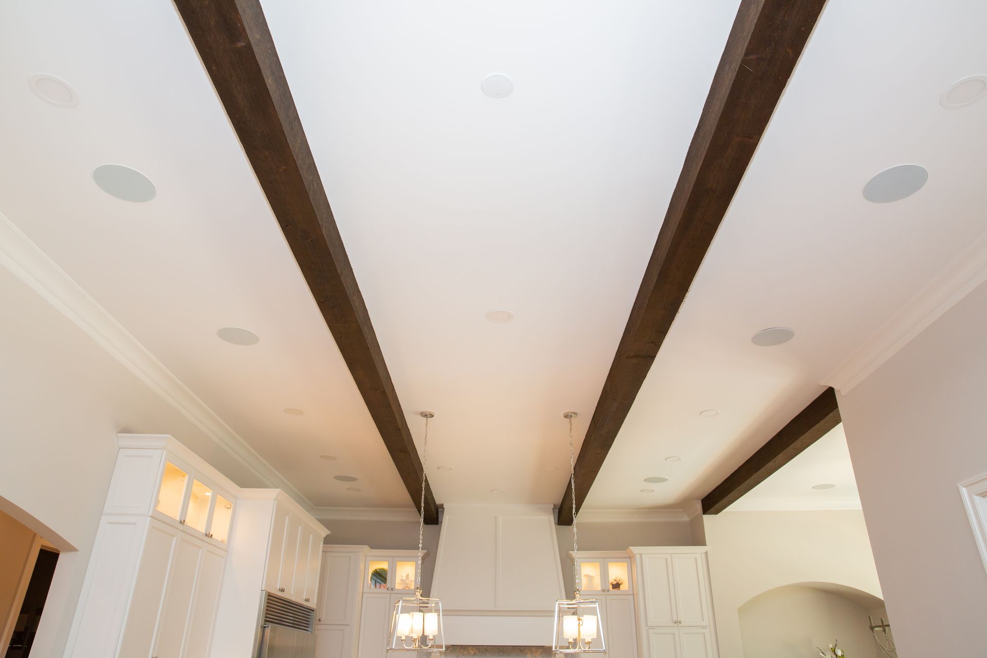 Finished luxury residential interior with discreet architectural in-ceiling speakers delivering whole-home pipe-in music