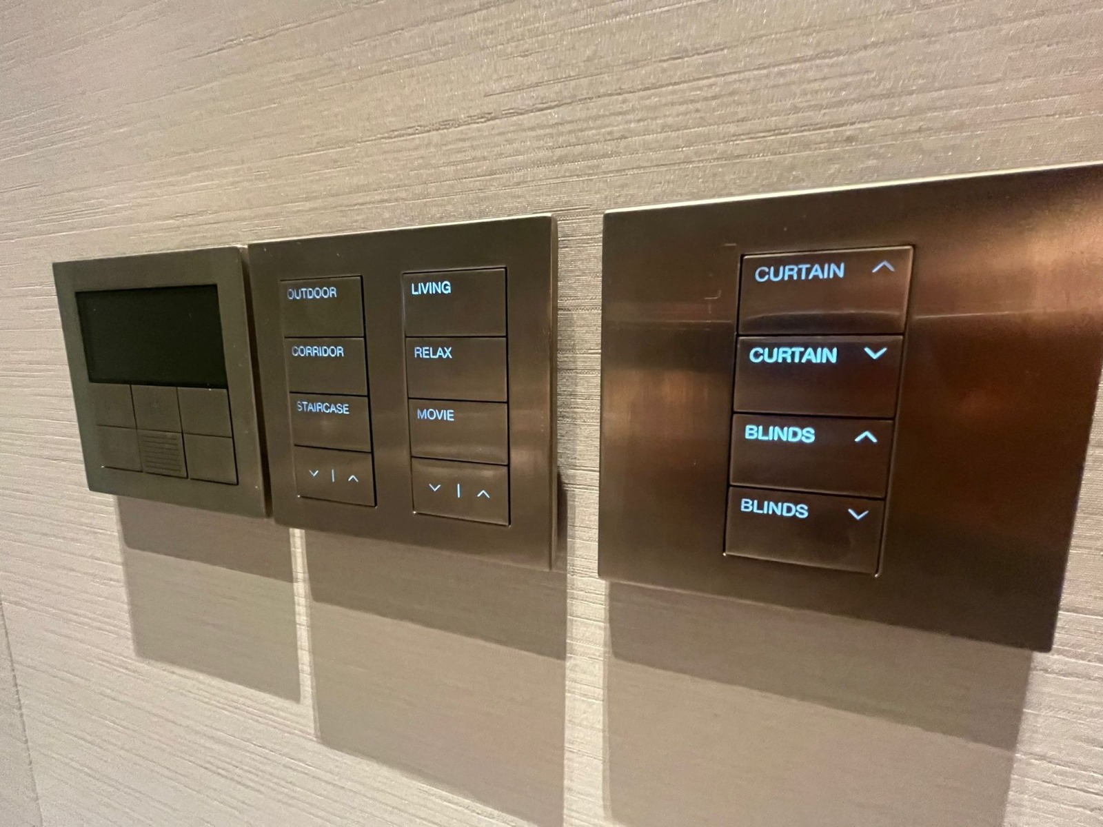 Architectural lighting control keypad installed on a residential wall finish